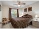 Bedroom with a queen-size bed, window, and ceiling fan at 15729 Greater Groves Blvd, Clermont, FL 34714