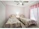 Bedroom with two twin beds and ceiling fan at 15729 Greater Groves Blvd, Clermont, FL 34714