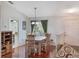 Dining area with a light wood table and chairs, and a view to the kitchen at 15729 Greater Groves Blvd, Clermont, FL 34714