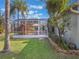 View of house exterior showcasing the screened patio and landscaping at 15729 Greater Groves Blvd, Clermont, FL 34714