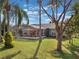 Backyard view of home showcasing screened patio and green lawn at 15729 Greater Groves Blvd, Clermont, FL 34714