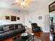 Living room with leather furniture, hardwood floors, and a ceiling fan at 15729 Greater Groves Blvd, Clermont, FL 34714