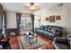 Living room with dark leather furniture, hardwood floors, and a fireplace at 15729 Greater Groves Blvd, Clermont, FL 34714