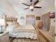 Large main bedroom with ceiling fan and comfortable seating area at 15729 Greater Groves Blvd, Clermont, FL 34714