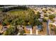 Aerial shot of a residential neighborhood near wooded area, featuring well-kept homes and green lawns at 1617 Myrtle Lake Ave, Fruitland Park, FL 34731