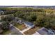 Aerial view of a neighborhood featuring a two-story house with a driveway and green landscaping at 1617 Myrtle Lake Ave, Fruitland Park, FL 34731