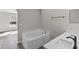 Bathroom featuring vanity with sink and a soaking tub at 1617 Myrtle Lake Ave, Fruitland Park, FL 34731