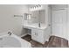 Modern bathroom featuring vanity with sink, soaking tub and large mirror at 1617 Myrtle Lake Ave, Fruitland Park, FL 34731