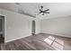 Bedroom with hardwood floors, ceiling fan, and a connecting bathroom at 1617 Myrtle Lake Ave, Fruitland Park, FL 34731