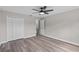 Neutral bedroom with ceiling fan, closet, and wood floors at 1617 Myrtle Lake Ave, Fruitland Park, FL 34731