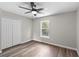 Bedroom features a ceiling fan, wood floors, and a closet at 1617 Myrtle Lake Ave, Fruitland Park, FL 34731