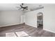 Main bedroom featuring arched accent wall, ensuite bathroom, and light wood flooring at 1617 Myrtle Lake Ave, Fruitland Park, FL 34731