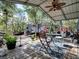 Covered patio with table and chairs, overlooking wooded area at 1668 Cr 543A, Sumterville, FL 33585