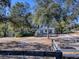 A charming single-story house surrounded by mature trees on a spacious lot with a rustic wooden fence at 1668 Cr 543A, Sumterville, FL 33585