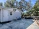 Gray shed with white door and window at 1668 Cr 543A, Sumterville, FL 33585