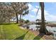 Picturesque backyard with a charming gazebo at the end of the private dock at 1702 N County Road 452, Eustis, FL 32726