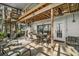 Open-air patio featuring wood ceiling, spiral stairs, ceiling fans, and dining area at 1702 N County Road 452, Eustis, FL 32726