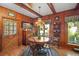 Inviting dining area featuring a round wood table, chairs, and wood-paneled walls at 1702 N County Road 452, Eustis, FL 32726