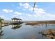 Lake view of a covered dock extending into the water with reflections of the sky at 1702 N County Road 452, Eustis, FL 32726