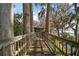 Scenic wooden walkway surrounded by lush greenery, leading to the water at 1702 N County Road 452, Eustis, FL 32726