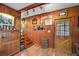 Welcoming entryway with hardwood floors, staircase, and decorative wood paneling at 1702 N County Road 452, Eustis, FL 32726