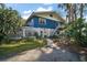 Unique two-story home with stone accents, a balcony, and a well-manicured front yard and mature landscaping at 1702 N County Road 452, Eustis, FL 32726