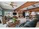 Cozy living room with wood beam ceilings, a stone fireplace, and comfortable seating at 1702 N County Road 452, Eustis, FL 32726