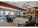 Spacious living room featuring a stone fireplace, wood beam ceiling, and views of the outdoor scenery at 1702 N County Road 452, Eustis, FL 32726