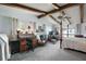 Bright main bedroom featuring a four-poster bed, ceiling fan, exposed beams and desk at 1702 N County Road 452, Eustis, FL 32726