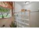 Bright bathroom showcases glass block shower, with a garden window providing natural light at 1702 N County Road 452, Eustis, FL 32726