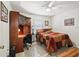 Bedroom with ceiling fan, a window with blinds, and a desk with matching cabinet at 17180 Se 115Th Terrace Rd, Summerfield, FL 34491