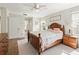 Relaxing bedroom with natural light, ceiling fan, and wood-look floors at 17180 Se 115Th Terrace Rd, Summerfield, FL 34491