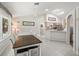 Bright dining area next to a kitchen with a breakfast bar and stainless steel appliances at 17180 Se 115Th Terrace Rd, Summerfield, FL 34491