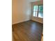 Well-lit bedroom with new flooring and a window at 17202 Sandalwood Dr # 202, Wildwood, FL 34785