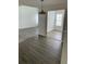 Open dining area with vinyl flooring and access to kitchen at 17202 Sandalwood Dr # 202, Wildwood, FL 34785