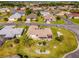 Aerial shot of a well-kept home, showcasing the lawn, landscaping, screened lanai, and neighborhood at 17457 Se 121St Cir, Summerfield, FL 34491