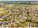 Aerial perspective of neighborhood featuring well-spaced homes, landscaped yards, and community features like lakes at 17457 Se 121St Cir, Summerfield, FL 34491