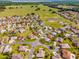 A high angle view of a residential neighborhood, including winding roads, ponds, and green spaces at 17457 Se 121St Cir, Summerfield, FL 34491