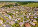 Community aerial view highlighting the layout of homes with manicured lawns, neighborhood streets, and landscaping at 17457 Se 121St Cir, Summerfield, FL 34491