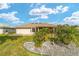 Backyard featuring lush landscaping, mature palms, and a screened lanai at 17457 Se 121St Cir, Summerfield, FL 34491