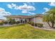 Charming single-story home featuring a well-manicured front lawn, mature landscaping, and a welcoming entryway at 17457 Se 121St Cir, Summerfield, FL 34491