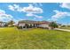 Beautiful single-story home with a green lawn and mature palm trees, set in a well-maintained neighborhood at 17457 Se 121St Cir, Summerfield, FL 34491