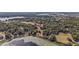 Aerial view of the home located in a wooded, lake community featuring a sprawling, well-treed landscape at 1825 Myrtle Lake Ave, Fruitland Park, FL 34731