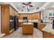 Spacious kitchen featuring wood cabinets, granite countertops, and stainless steel appliances at 1825 Myrtle Lake Ave, Fruitland Park, FL 34731