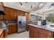 Gourmet kitchen area with stainless steel appliances, custom cabinets, and bar seating overlooks the lanai at 1825 Myrtle Lake Ave, Fruitland Park, FL 34731