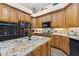 Well-equipped kitchen featuring wood cabinets, granite countertops, and stainless steel appliances at 1825 Myrtle Lake Ave, Fruitland Park, FL 34731