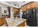 Close up of kitchen island with granite countertop and stainless steel appliances at 1825 Myrtle Lake Ave, Fruitland Park, FL 34731