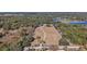 Aerial image highlighting property boundaries, mature trees, lake access, and overall expansive land at 1825 Myrtle Lake Ave, Fruitland Park, FL 34731