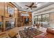 Inviting living room features a fireplace, built-in shelves, and sliding glass doors to the pool area at 1825 Myrtle Lake Ave, Fruitland Park, FL 34731