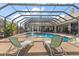 Inviting screened pool with fountain feature and lounge chairs, perfect for relaxation and enjoying the outdoors at 1825 Myrtle Lake Ave, Fruitland Park, FL 34731